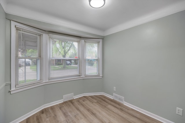 spare room with light wood finished floors and baseboards