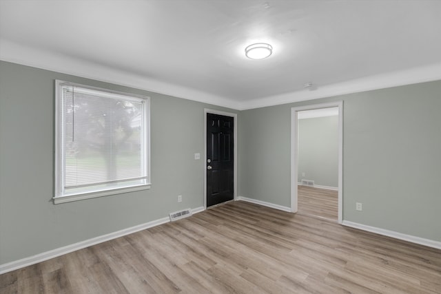 empty room featuring wood finished floors and baseboards