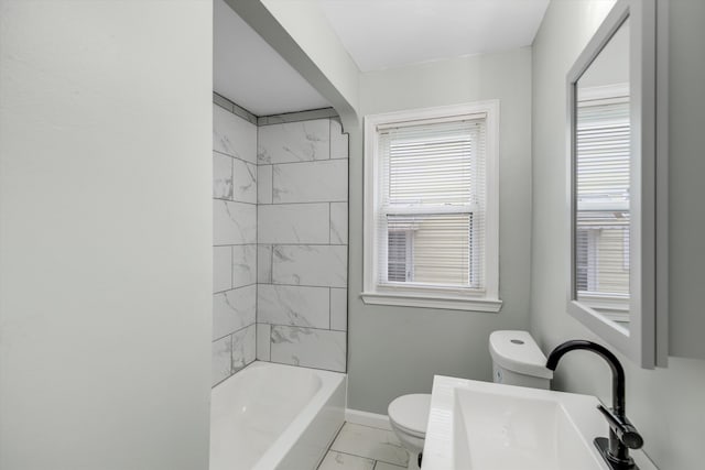 bathroom with toilet, marble finish flooring, baseboards, a sink, and shower / tub combination