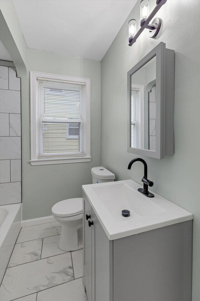 bathroom featuring marble look tile flooring, toilet, a bathtub, vanity, and a shower