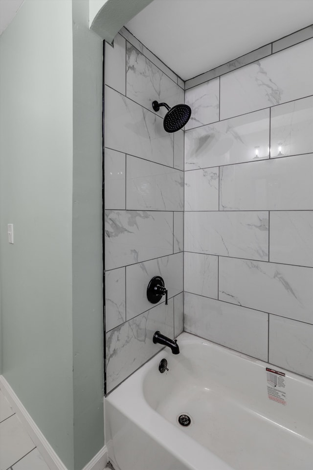 full bathroom featuring bathing tub / shower combination and baseboards