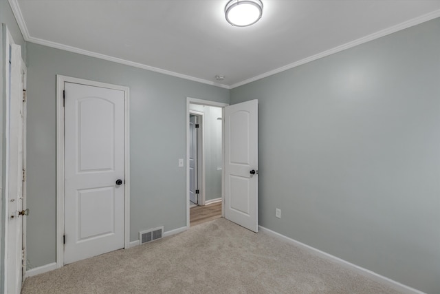 unfurnished bedroom featuring ornamental molding, carpet, and baseboards