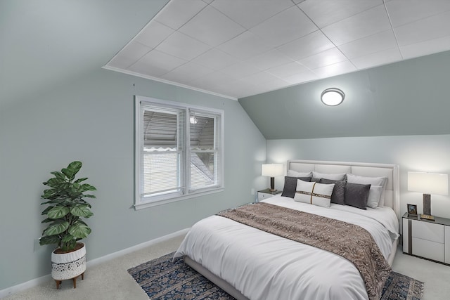 bedroom featuring light carpet, lofted ceiling, and baseboards