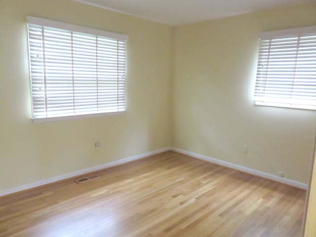 unfurnished room featuring light wood-style floors and baseboards