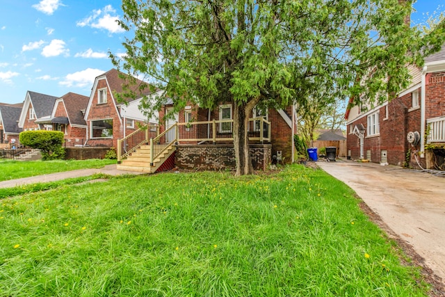 9171 Bishop St, Detroit, MI 48224 - view of front of home with brick siding, a residential view, and driveway