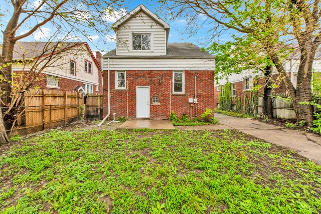 9171 Bishop St, Detroit, MI 48224 - back of property with brick siding, a fenced backyard, and a patio