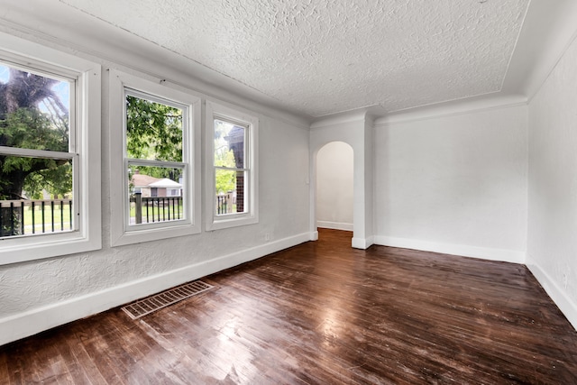 9171 Bishop St, Detroit, MI 48224 - spare room featuring arched walkways, a textured ceiling, plenty of natural light, and baseboards