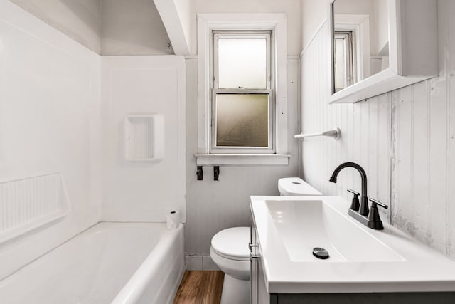9171 Bishop St, Detroit, MI 48224 - bathroom with toilet, wood finished floors, tub / shower combination, and vanity
