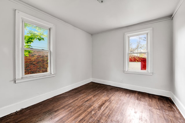 9171 Bishop St, Detroit, MI 48224 - empty room featuring baseboards, dark wood-style floors, and crown molding