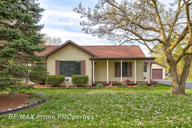 ranch-style house featuring a porch, a front lawn, a shingled roof, asphalt driveway, and a garage