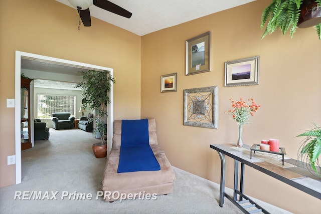 sitting room featuring carpet floors and a ceiling fan