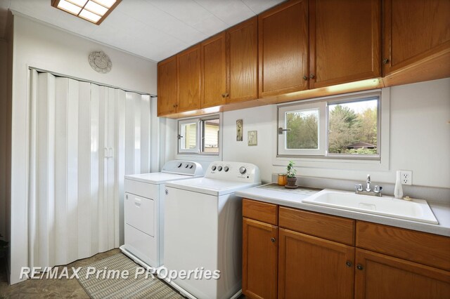 laundry room with washer and clothes dryer and cabinet space