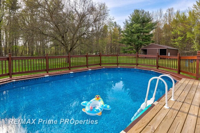 view of pool with a wooden deck