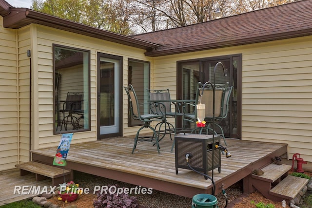 deck with outdoor dining area