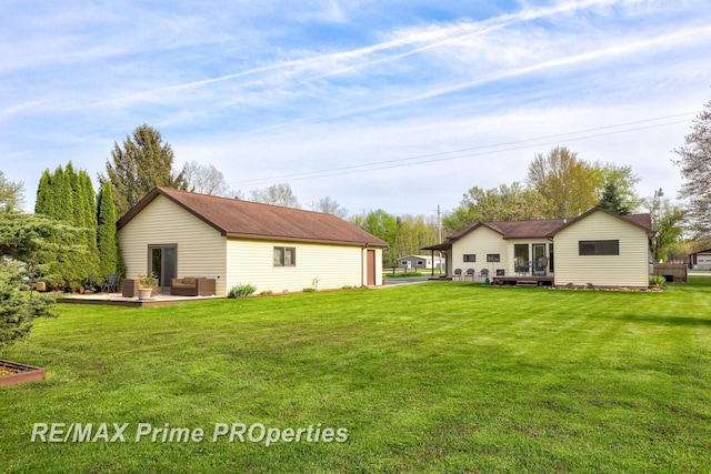 rear view of house with an outdoor living space, a lawn, and a wooden deck