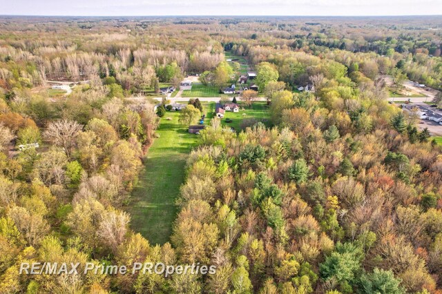 aerial view of property's location featuring a heavily wooded area