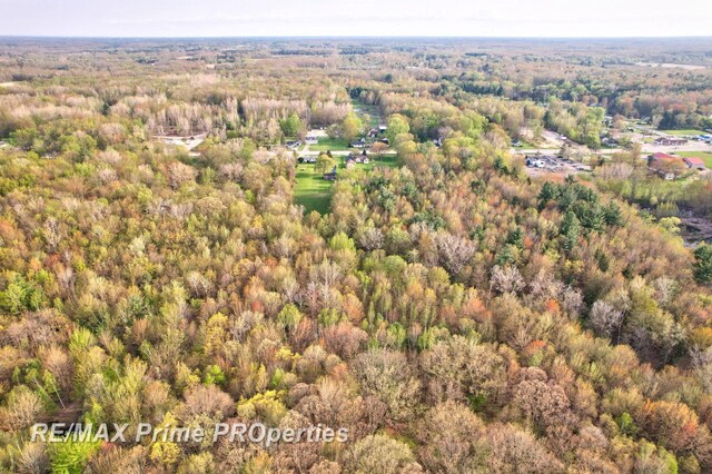 aerial overview of property's location with a heavily wooded area