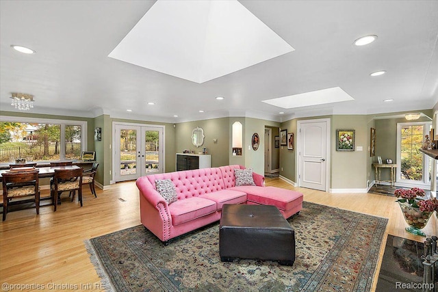 26335 Woodlore Rd, Franklin, MI 48025 - living area with a skylight, recessed lighting, french doors, light wood-type flooring, and crown molding