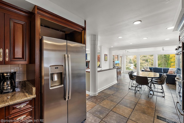 26335 Woodlore Rd, Franklin, MI 48025 - kitchen featuring stainless steel refrigerator with ice dispenser, recessed lighting, stone countertops, tasteful backsplash, and open floor plan