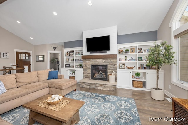 2044 Canopy Dr SW, Byron Center, MI 49315 - living area featuring vaulted ceiling, wood finished floors, a stone fireplace, recessed lighting, and baseboards
