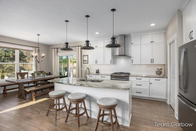 2044 Canopy Dr SW, Byron Center, MI 49315 - kitchen with wall chimney exhaust hood, appliances with stainless steel finishes, a sink, backsplash, and white cabinets
