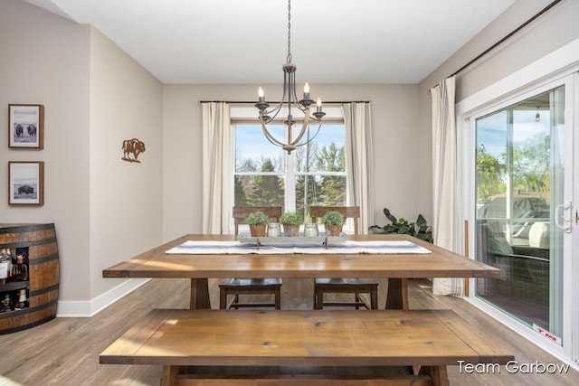 2044 Canopy Dr SW, Byron Center, MI 49315 - dining space with a chandelier, wood finished floors, and baseboards