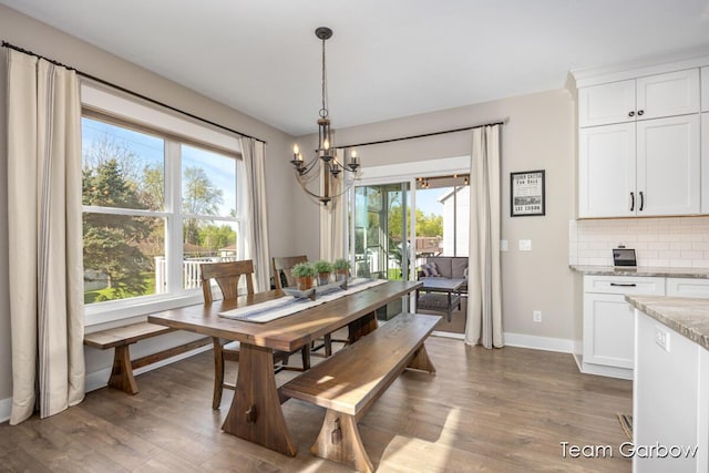 2044 Canopy Dr SW, Byron Center, MI 49315 - dining area with a chandelier, baseboards, and wood finished floors
