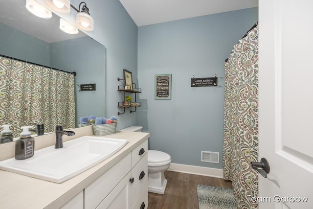 2044 Canopy Dr SW, Byron Center, MI 49315 - bathroom with wood finished floors, toilet, vanity, and baseboards