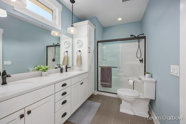 2044 Canopy Dr SW, Byron Center, MI 49315 - bathroom with a stall shower, toilet, double vanity, baseboards, and recessed lighting