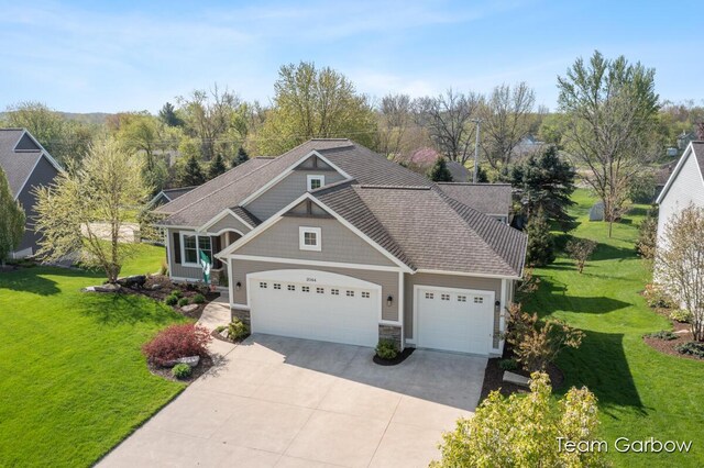 2044 Canopy Dr SW, Byron Center, MI 49315 - craftsman-style home with concrete driveway, a garage, a front yard, and stone siding