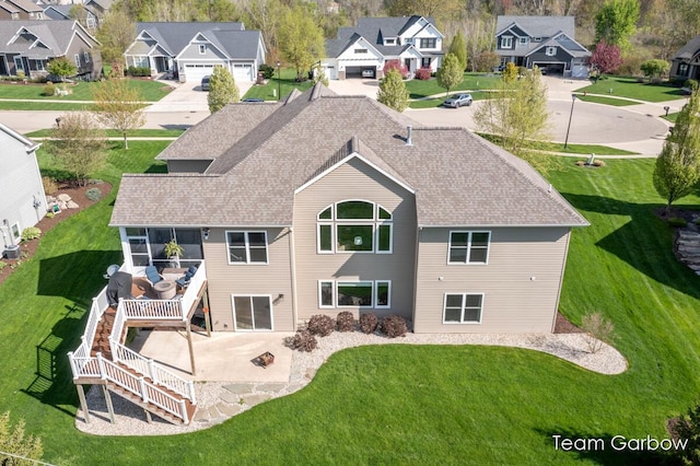 2044 Canopy Dr SW, Byron Center, MI 49315 - rear view of property featuring a residential view, stairway, a patio, a shingled roof, and a yard
