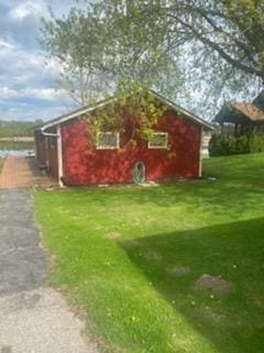 12765 NE Gregware Dr NE, Sand Lake, MI 49343 - view of property exterior with a yard