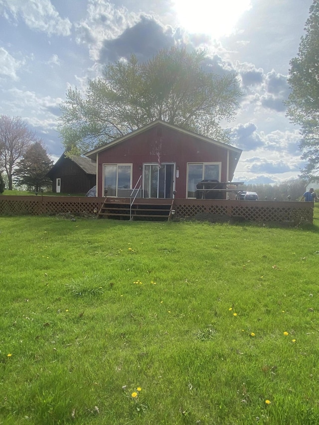 12765 NE Gregware Dr NE, Sand Lake, MI 49343 - rear view of property featuring a deck and a lawn
