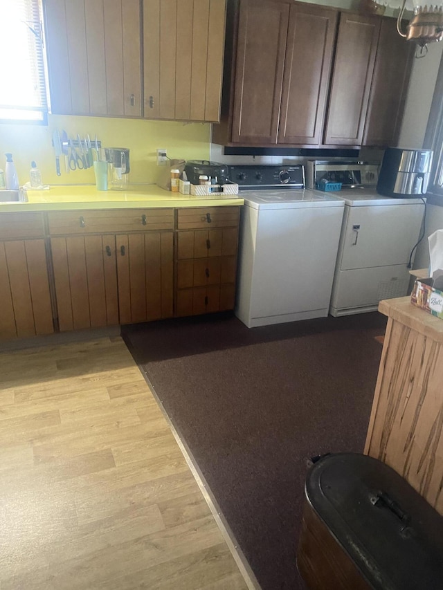 12765 NE Gregware Dr NE, Sand Lake, MI 49343 - kitchen featuring light countertops, light wood finished floors, and washer and dryer