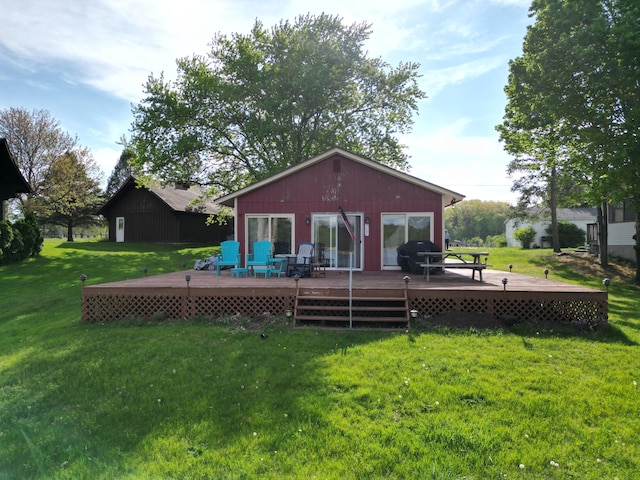 12765 NE Gregware Dr NE, Sand Lake, MI 49343 - back of property with a wooden deck and a lawn