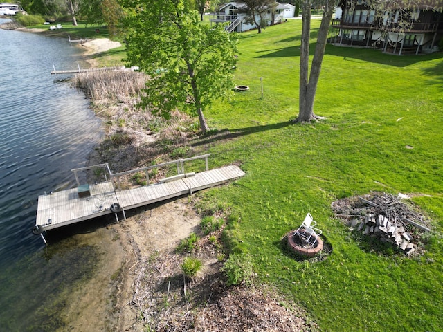 12765 NE Gregware Dr NE, Sand Lake, MI 49343 - view of green lawn with a water view and a boat dock