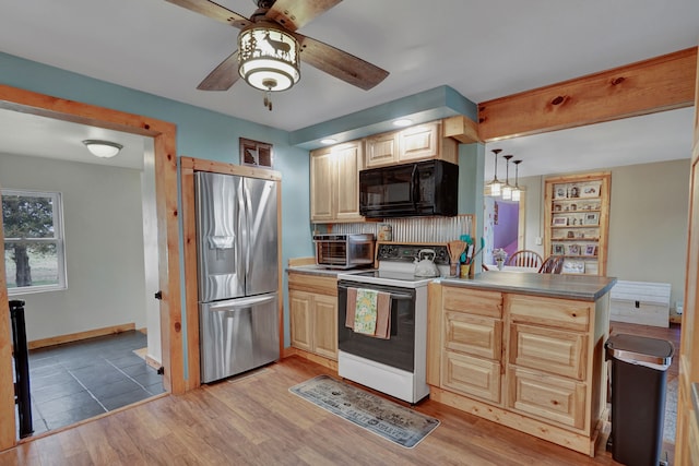 kitchen with stainless steel refrigerator with ice dispenser, black microwave, white electric stove, a peninsula, and a ceiling fan