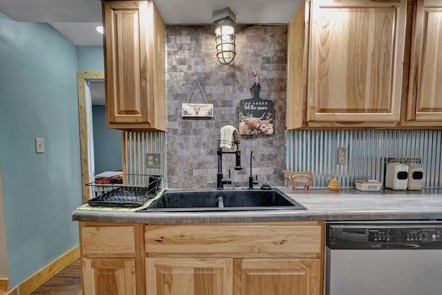 kitchen featuring dishwasher, a sink, light brown cabinets, and tasteful backsplash