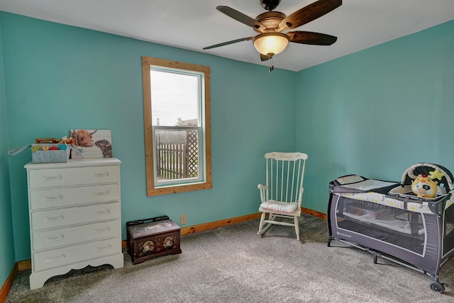 carpeted bedroom featuring baseboards and a ceiling fan