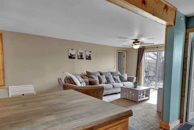 living room featuring ceiling fan and carpet