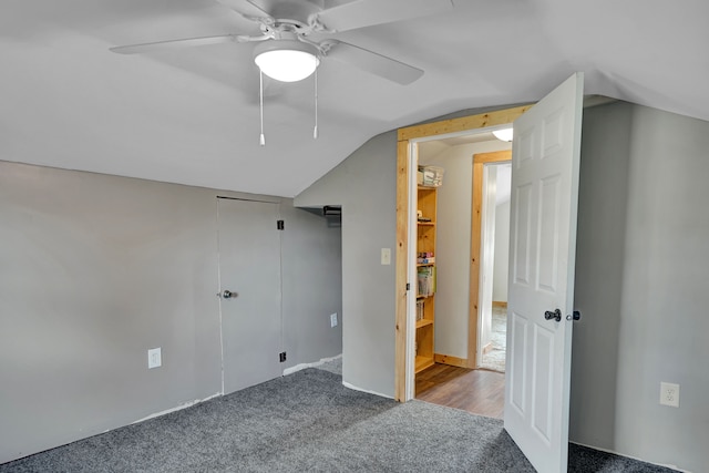 unfurnished bedroom with vaulted ceiling, carpet flooring, and ceiling fan