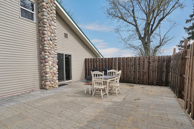 view of patio featuring outdoor dining space and fence