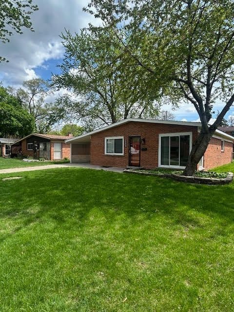 29424 Shirley Ave, Madison Heights, MI 48071 - ranch-style home featuring a carport, brick siding, and a front yard