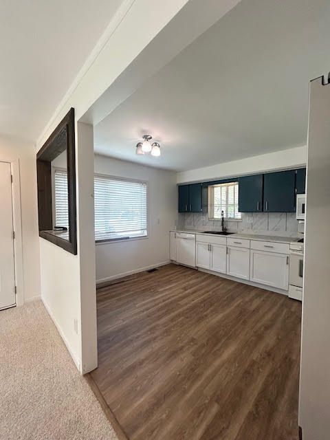 29424 Shirley Ave, Madison Heights, MI 48071 - kitchen featuring white appliances, a sink, backsplash, light countertops, and baseboards