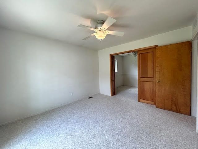 29424 Shirley Ave, Madison Heights, MI 48071 - unfurnished bedroom with light colored carpet, a closet, and a ceiling fan