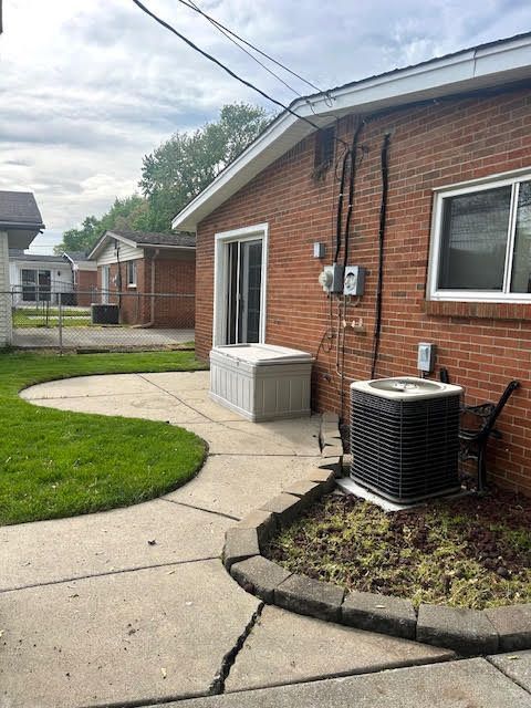 29424 Shirley Ave, Madison Heights, MI 48071 - rear view of property with central AC, brick siding, and fence