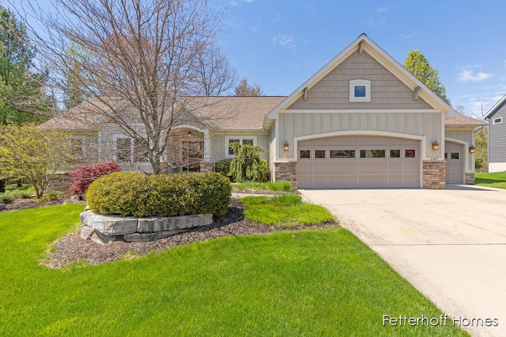 1307 Glen Ellyn Dr SE, Grand Rapids, MI 49546 - craftsman house featuring board and batten siding, a garage, a front lawn, and stone siding