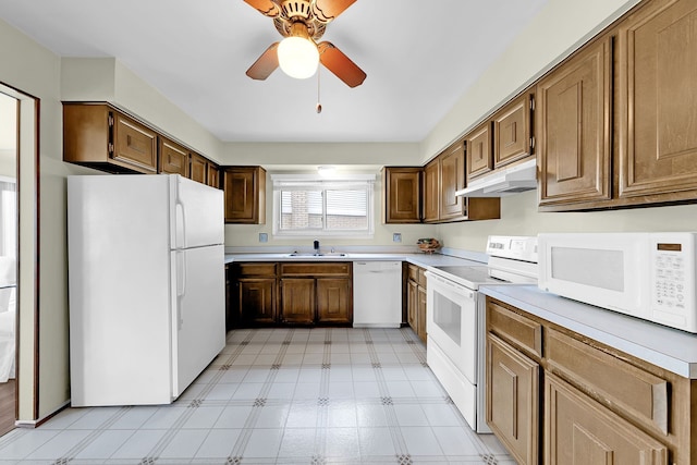 15690 Grainger Dr, Clinton Township, MI 48038 - kitchen featuring white appliances, under cabinet range hood, a sink, light flooring, and light countertops