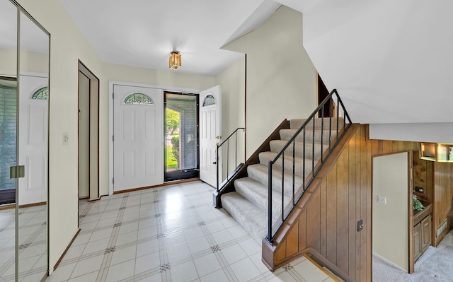 15690 Grainger Dr, Clinton Township, MI 48038 - entrance foyer featuring stairway, wood walls, light flooring, and baseboards