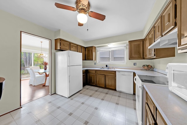 15690 Grainger Dr, Clinton Township, MI 48038 - kitchen featuring white appliances, under cabinet range hood, a sink, light flooring, and light countertops